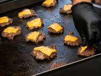 Cheeseburgers cooking on the griddle