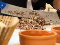 Carving roast lamb at a live station