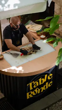 Chef preparing food at a La Table Ronde station