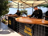 Live cooking stations beneath an outdoor canopy
