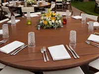 Outdoor dining table set with flowers and glassware